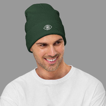 Man wearing a green beanie with a eye logo on a white background
