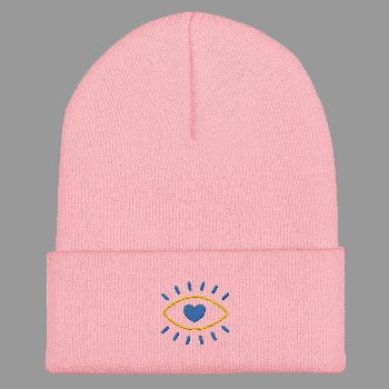 Pink beanie with embroidered design on a white background