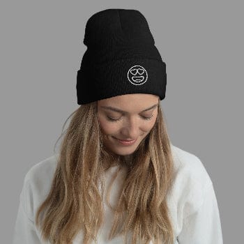 Woman wearing a black beanie with a white logo against a light gray background