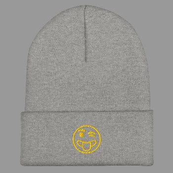 Gray beanie with a yellow smiley face emblem on a white background