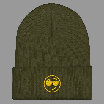 Green beanie with a yellow smiley face design on a white background