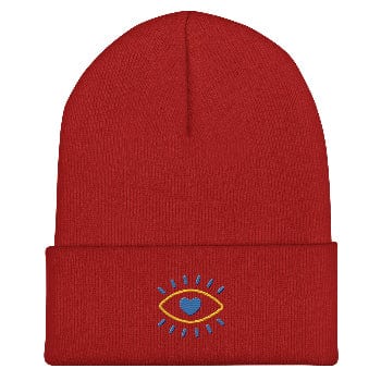 Red beanie with an embroidered design on a white background