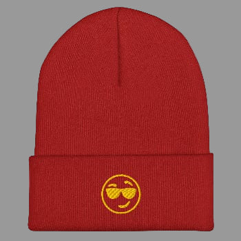 Red beanie with a yellow smiley face design on a white background