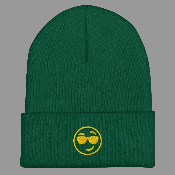 Green beanie with a yellow smiley face design on a white background