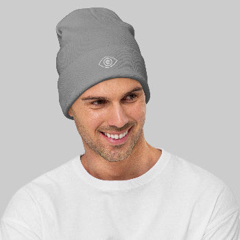 Man wearing a gray beanie with a eye logo on a white background