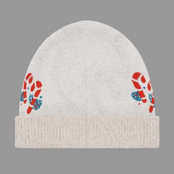 Beige knit beanie with red and blue floral patterns on a white background