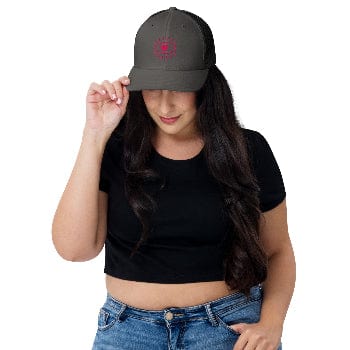 Woman wearing a black cap with a red design on a white background
