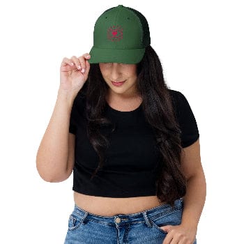 Woman wearing a green cap with a red logo on a white background