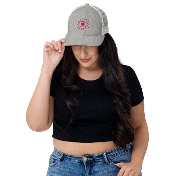Woman wearing a gray cap with a red logo on a white background