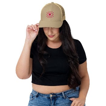 Woman wearing a beige cap with a red logo on a white background