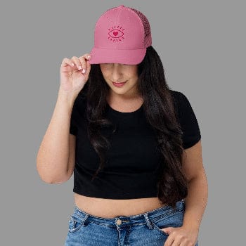 Woman wearing a pink cap with a design on a white background