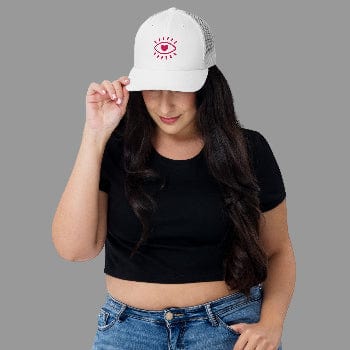 Woman wearing a white cap with a red logo on a white background