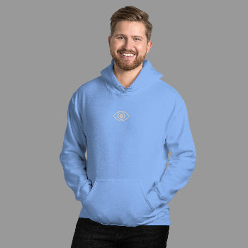 Man wearing a light blue hoodie with a logo against a white brick wall